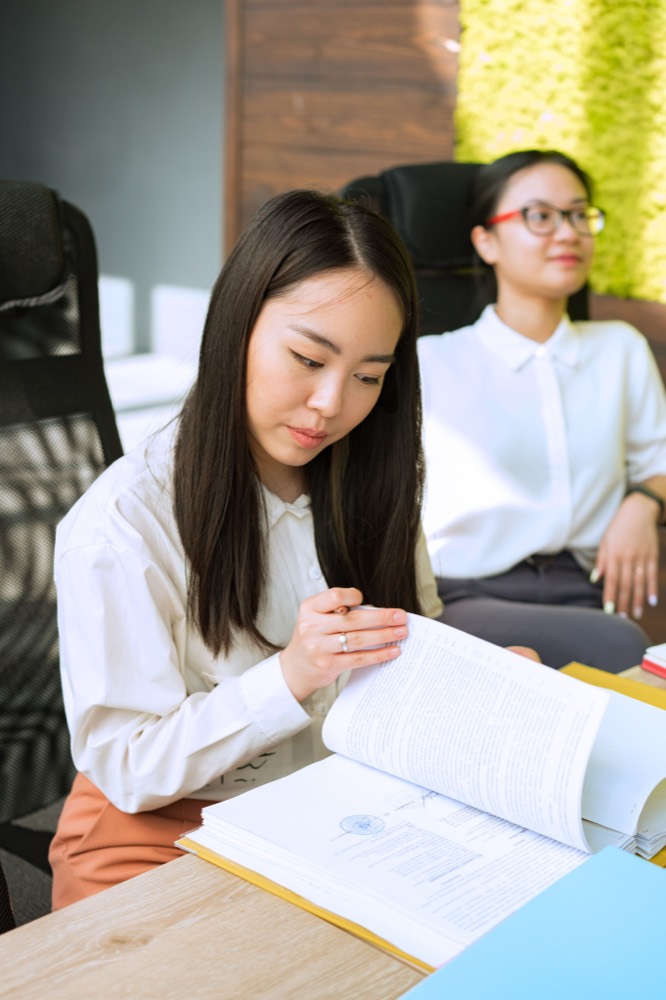 A broker reviewing enrollment documentation with a colleague
